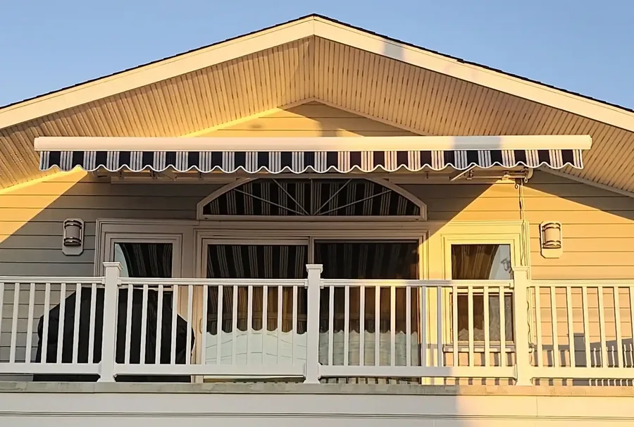 Striped retractable awning on a South Jersey shore home — All Seasons Awnings